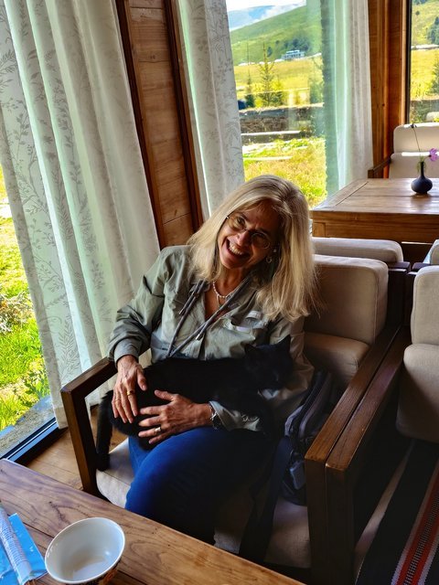Traveler with a black cat at a guesthouse