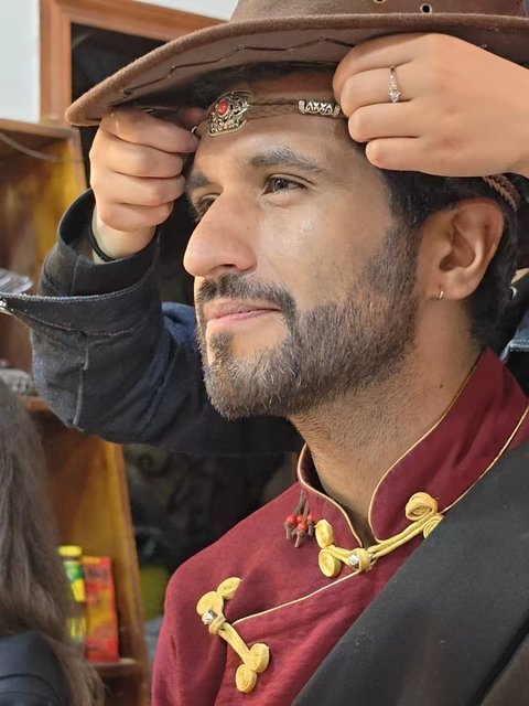 Traveler trying on a traditional Tibetan hat