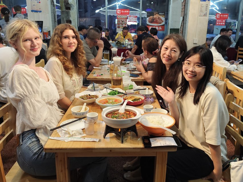Travelers sharing a hotpot dinner in Chengdu